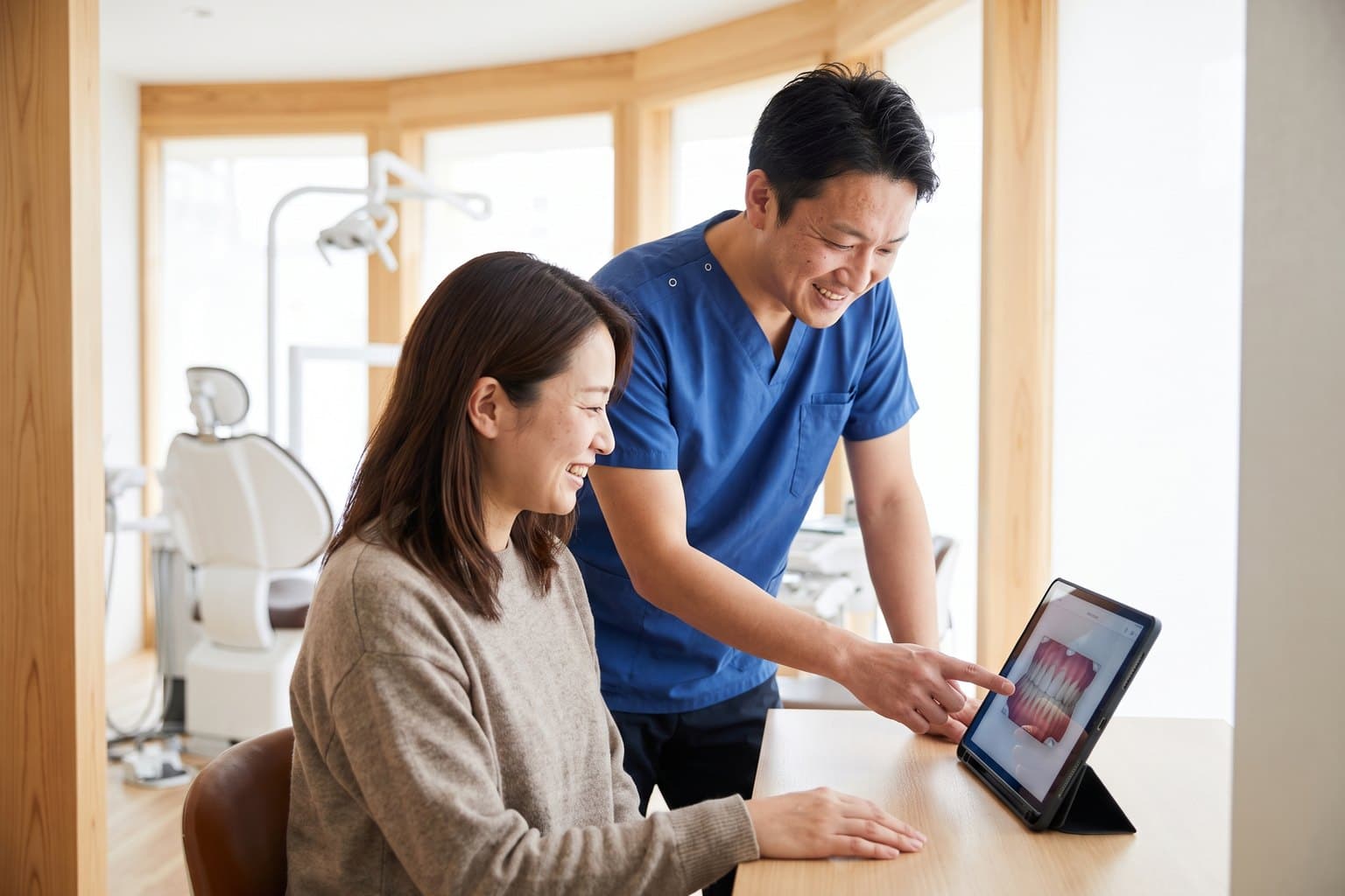 Dentist reviewing a treatment plan with a patient in a modern surgery